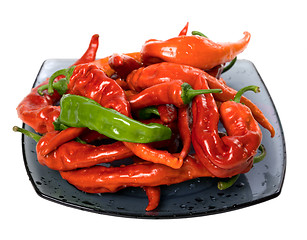 Image showing Red and green peppers on glass plate