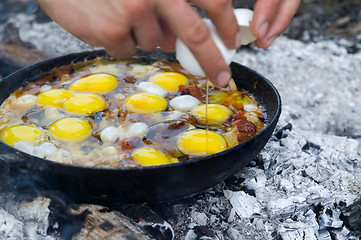 Image showing Fried eggs. Cooking on the campfire.