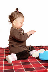 Image showing Baby girl sitting on blanket.