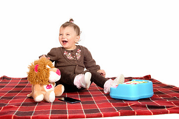 Image showing Baby having fun with her toys.