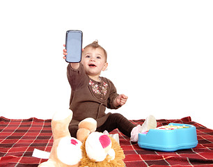 Image showing Baby holding up a cell phone.