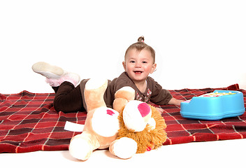 Image showing Smiling girl lying on floor.