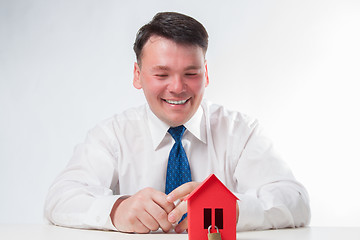 Image showing Man with a red paper house