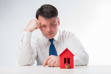 Image showing Sad Man with a red paper house