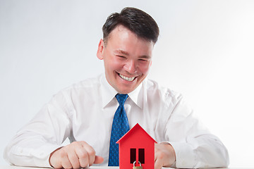 Image showing Man with a red paper house