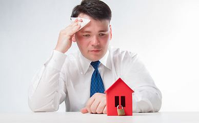 Image showing Sad Man with a red paper house