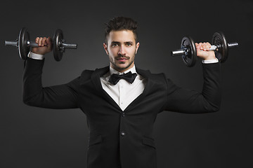 Image showing Young man lifting weights