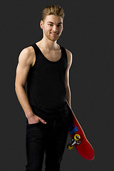 Image showing Young man with a skateboard