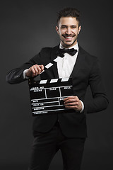 Image showing Man holding a clapboard