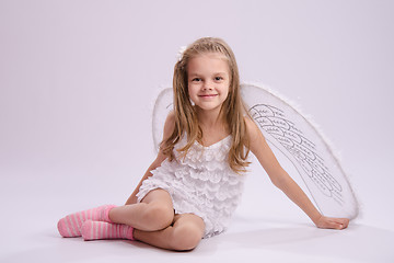 Image showing Sitting girl in angel costume