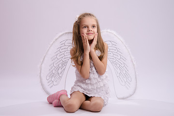 Image showing Seated girl with angel wings