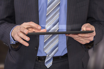 Image showing Business man using tablet