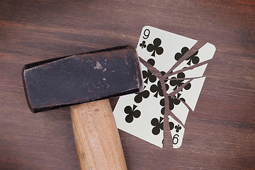 Image showing Hammer with a broken card, nine of clubs