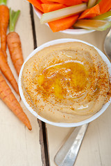 Image showing fresh hummus dip with raw carrot and celery 