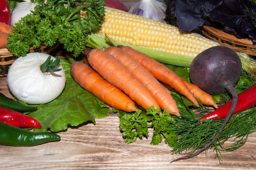 Image showing Carrots and fresh greenery