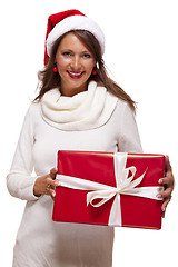 Image showing Pretty woman in a Santa hat with a large gift