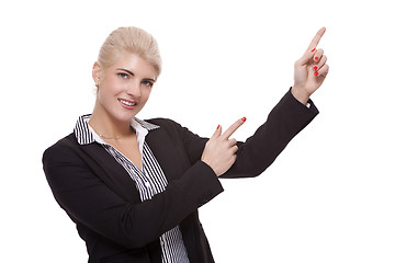 Image showing Businesswoman Pointing Up While Looking at Camera