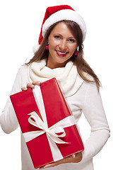 Image showing Pretty woman in a Santa hat with a large gift