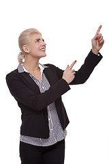 Image showing Businesswoman Pointing Up While Looking at Camera