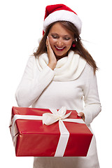 Image showing Pretty woman in a Santa hat with a large gift