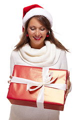 Image showing Pretty woman in a Santa hat with a large gift