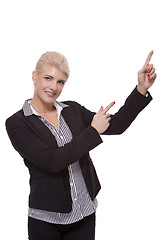 Image showing Businesswoman Pointing Up While Looking at Camera