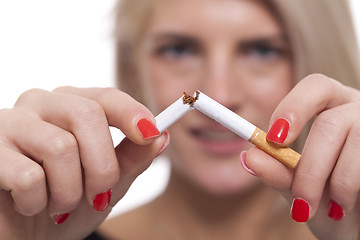 Image showing Close up Young Woman Breaking a Cigarette Stick