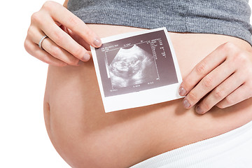 Image showing Pregnant woman displaying a prenatal ultrasound