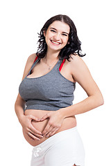 Image showing Young pregnant woman making a heart gesture