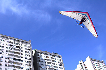 Image showing Hang glider over buildings
