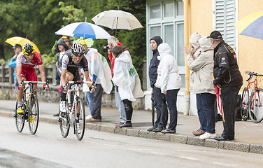 Image showing Two Cyclists Riding in the Rain