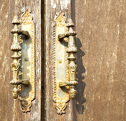 Image showing lentate abstract   rusty brass brown knocker in a   door 