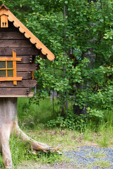 Image showing log hut in the park on a background of trees