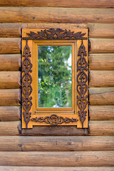 Image showing window with wooden architraves in the wooden house