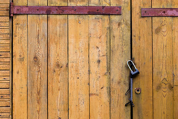 Image showing Wooden door with a padlock