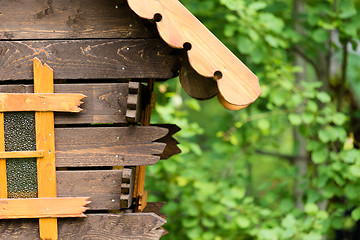 Image showing log hut in the park on a background of trees