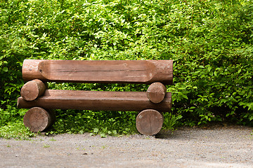 Image showing wooden bench in the park on a background of vegetation