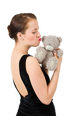 Image showing attractive kissing brunette holding teddy bear