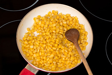 Image showing cooking sweet conn with wooden spoon