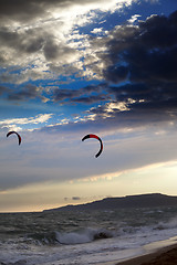 Image showing Two silhouette of power kites at sunset sky