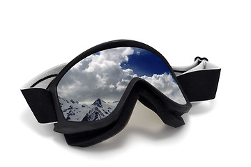 Image showing Ski goggles with reflection of cloudy mountains