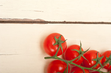 Image showing fresh cherry tomatoes on a cluster