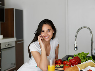 Image showing Young Woman Cooking in the kitchen