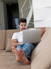 Image showing Man Relaxing On Sofa With Laptop