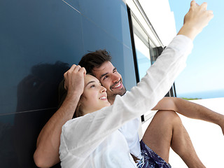 Image showing young couple making selfie together at home