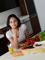 Image showing Young Woman Cooking in the kitchen