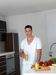 Image showing man cooking at home preparing salad in kitchen