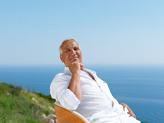 Image showing senior man sitting outside