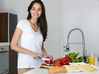 Image showing Young Woman Cooking in the kitchen