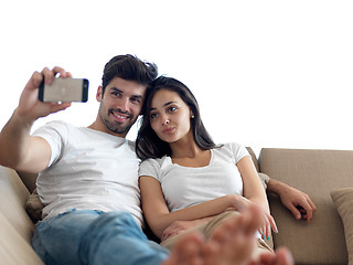 Image showing young couple making selfie together at home